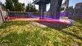Grab the Inverter that is behind the purple gate. Connect it to the red Emitter, the blue Receiver and place it down as far back as possible, so that it is visible through the purple gate.